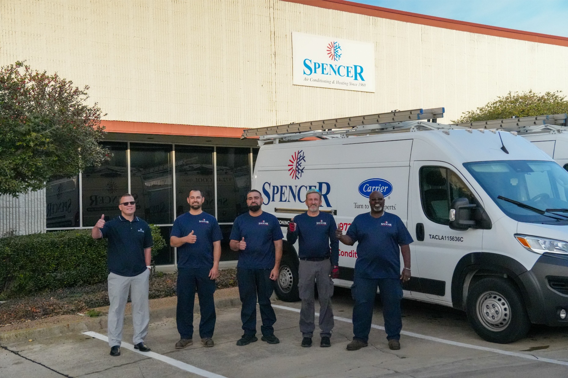 The Spencer crew today, in front of the Irving shop that has read 'Air Conditioning & Heating Since 1960' for three generations